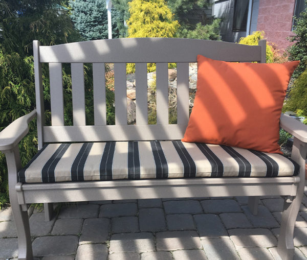 Twenty two inch pillow on a poly bench with a cushion.